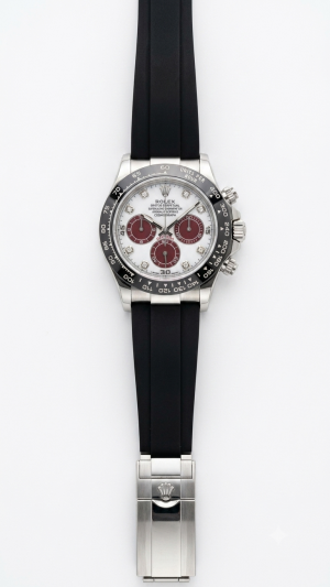Roleex Cosmograph Daytona chronograph white-and-red dial paired with a black rubber strap
